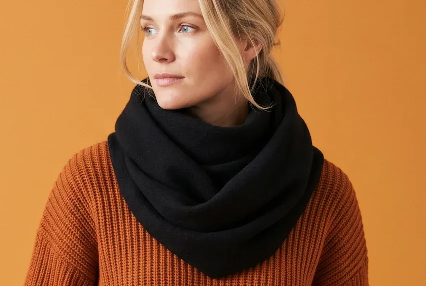 Female model wearing a colourful knit sweater in a colourful background