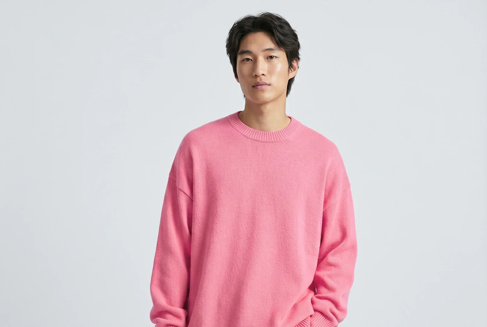 Model in a bright pink knit sweater.